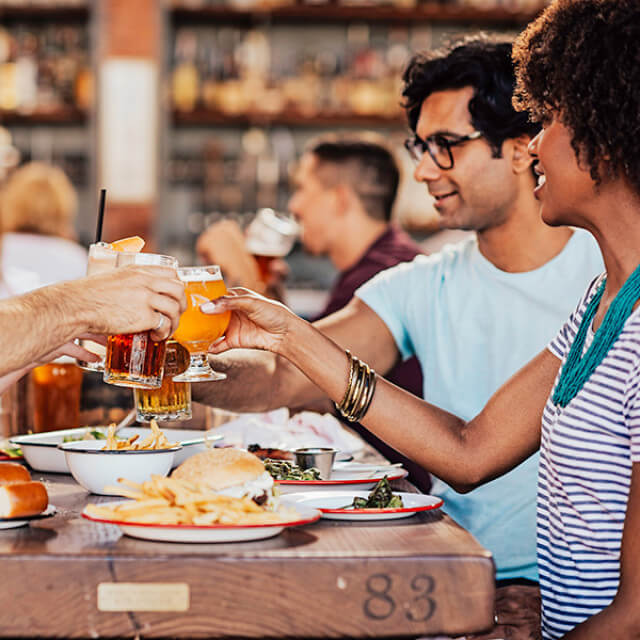 Friends share a meal with beers and cocktails in Sonoma, California